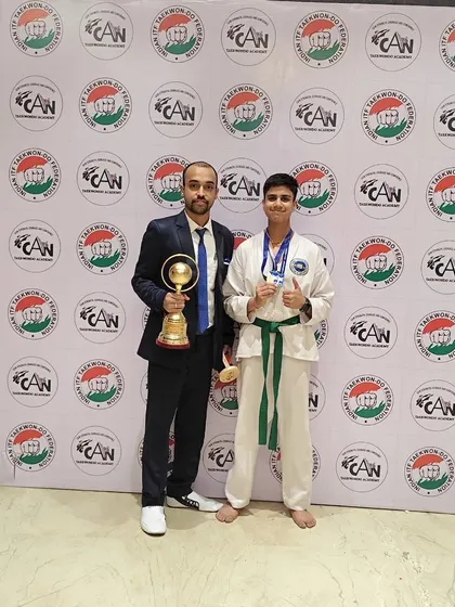 Celebrating a major win with my student, who is holding a championship trophy and his medals. Moments like these are a testament to his perseverance.
