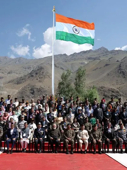 The official group photograph at the 25th Anniversary of Kargil Vijay Diwas, with the Indian flag flying proudly against the mountain backdrop. This was a truly historic moment to capture.