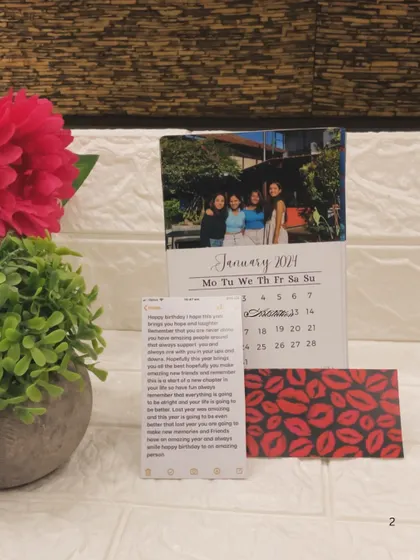 A custom desk calendar from last year, featuring a personal photo for each month and a wooden stand. I can create these for the new year with your favorite pictures and important dates.
