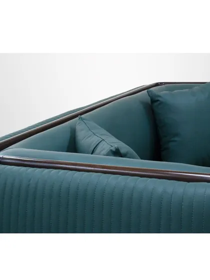 A close-up of the loveseat's arm and back, showing the fine piping detail and the texture of the channel-tufted fabric.