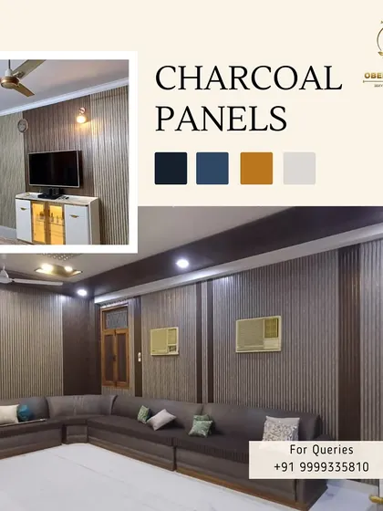 A living room featuring a full wall of our charcoal panels, creating a cozy yet modern backdrop for a large sectional sofa.