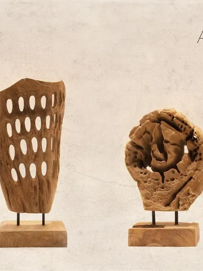 A pair of contrasting artifacts. One features the perforated design, while the other is a more solid, gnarled piece of teak, showcasing the diverse forms found in nature.
