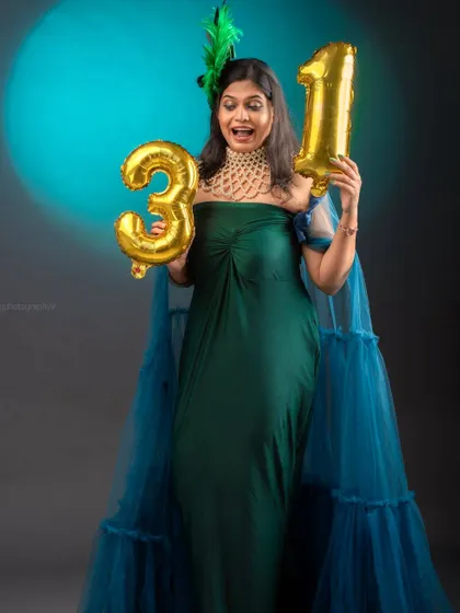 Celebrating a birthday in style with my peacock gown. The combination of emerald green and a blue tulle cape creates a unique and festive look.