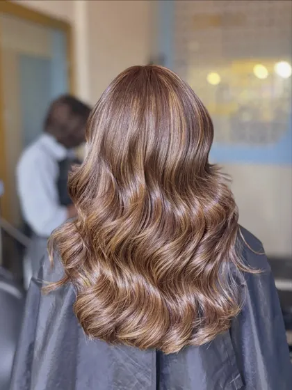 These are our Ginger Layers. The warm, ginger-toned highlights add a beautiful warmth and dimension to the hair, styled in classic waves.