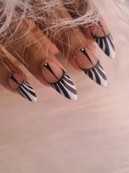 A close-up of our modern zebra print design on sharp stiletto nails, showcasing the clean lines and graphic appeal.
