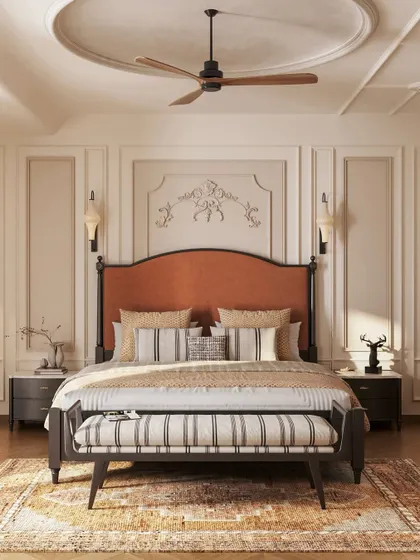 This master bedroom is a study in neoclassical elegance. We used classic wall moldings, a timeless two-poster bed with a rich rust-orange headboard, and a balanced, neutral palette to create a sanctuary that feels both grand and deeply restful.