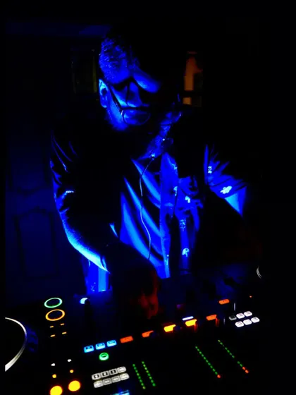 A moody shot of me at the decks, deep in concentration during a set in Goa. The blue light and intense focus capture the atmosphere of a late-night session.