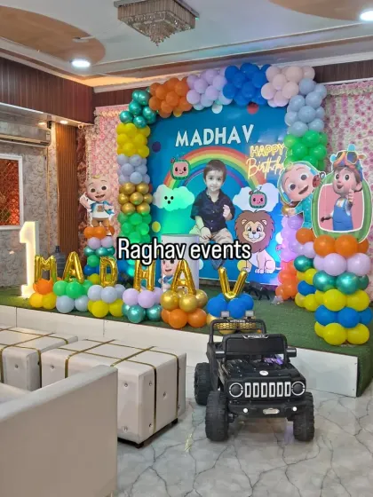 Another angle of the Cocomelon themed birthday party for Madhav. This view shows the addition of a toy jeep, making it a fun photo area for the kids.