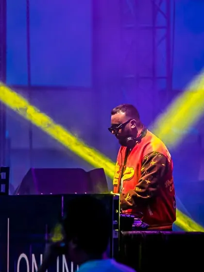 Caught in the spotlight during my festival set. The stage lighting and visuals add another layer to the musical journey.