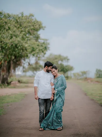 An affectionate portrait of a couple on a quiet road, surrounded by nature.