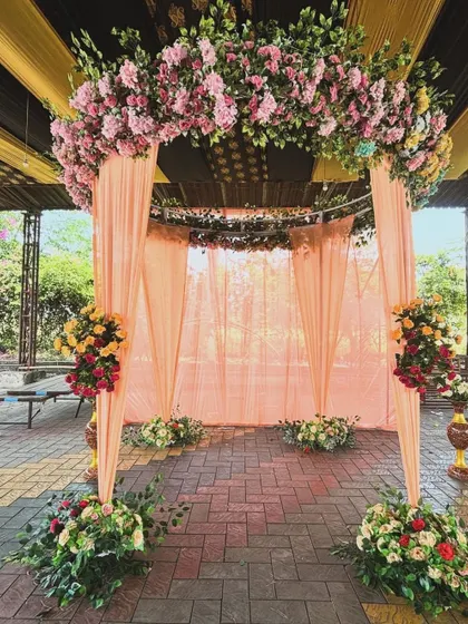 A full view of the elegant peach-colored archway, perfect for a sophisticated daytime ceremony or pre-wedding event.