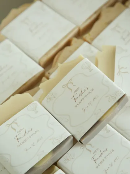 The soft, neutral tones of these custom-wrapped soaps were chosen to create a gender-neutral and elegant baby shower favor.