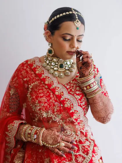 A quiet moment of reflection. This shot captures the intricate details of her jewelry and the soft, blended eyeshadow, creating a look of serene beauty.