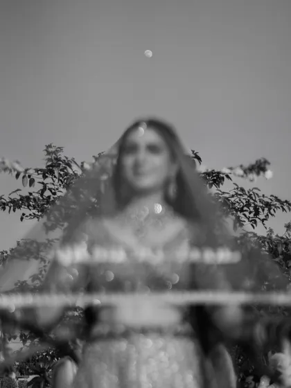 A beautifully blurred, artistic shot of the bride during her varmala entry. This was an unplanned, magical moment that perfectly captures the dreamlike quality of the day.