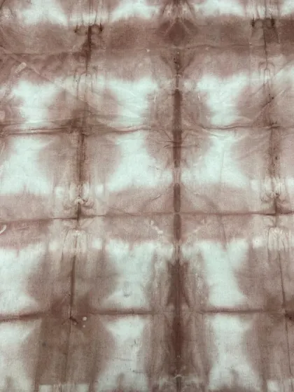 A grid-like pattern created by folding the fabric into squares before dyeing. This is a shibori-inspired technique.