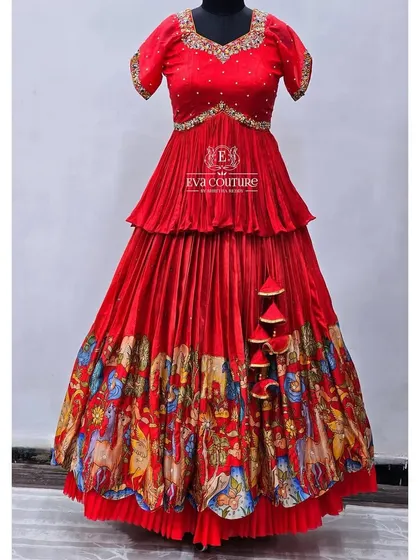 The same hand-painted gown design in a vibrant red. The detailed painting along the border of the skirt makes this a truly special occasion outfit.