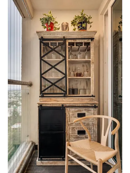 We converted a balcony in apartment 5212 into a functional and stylish bar area. The distressed-finish wood cabinet with barn-style hardware adds a rustic touch to the modern apartment.