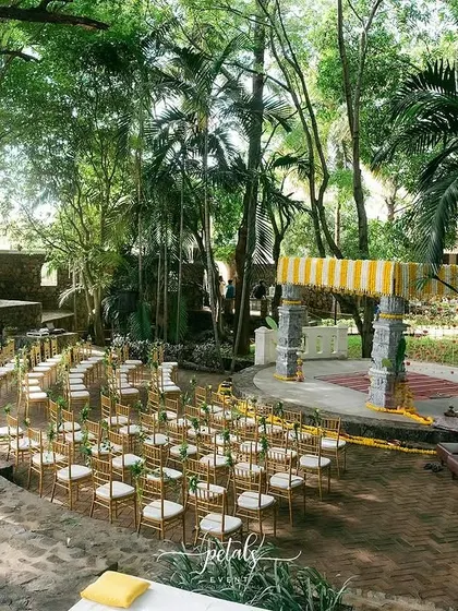 Another perspective of the beautiful, open-air wedding at Angana the Courtyard. The design respects the venue's architecture while adding a layer of celebratory tradition through flowers and decor.
