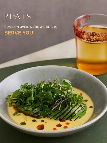 A warm invitation to our table. This dish of grilled avocado in a creamy sauce, paired with a signature cocktail, represents the welcoming and unforgettable experience I strive to create.