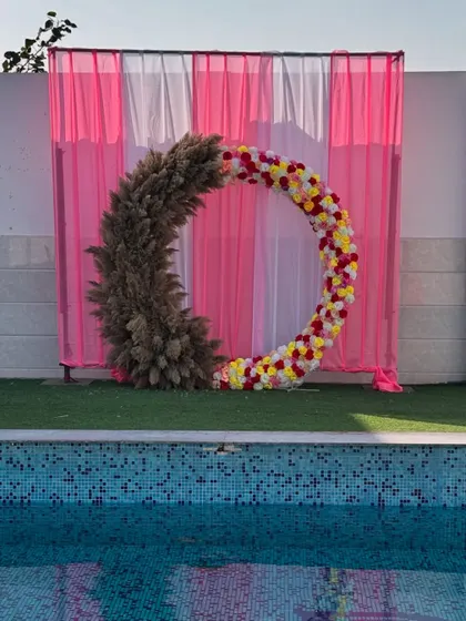 The decor sets the mood. A beautiful floral and pampas grass ring by the pool, part of a wedding event we catered.