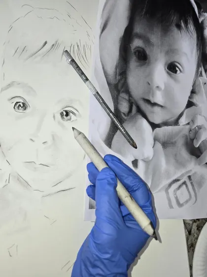 In our charcoal portrait workshops, we teach you to work from photo references to create emotionally resonant art. This in-progress shot shows the blending process used to achieve soft, realistic skin tones.
