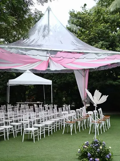 The guest seating area is just as important as the main stage. For this garden party, I used elegant white chairs under a pink and white draped tent to continue the whimsical and airy feel of the event.