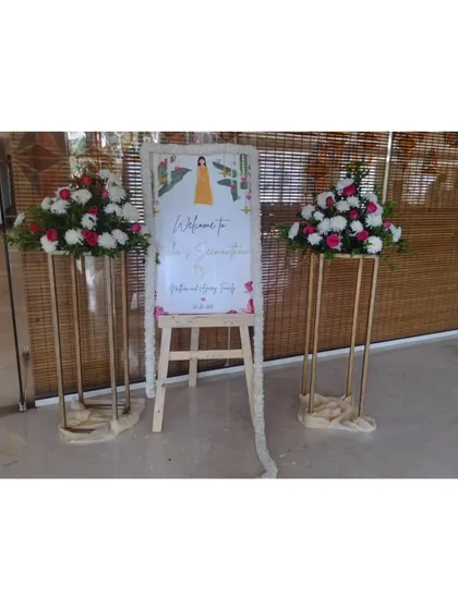 A welcome sign for a puberty ceremony, decorated with flowers.