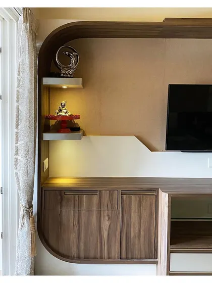 The custom-designed entertainment unit in the master bedroom features curved wood elements and integrated shelving, providing a stylish and functional storage solution.