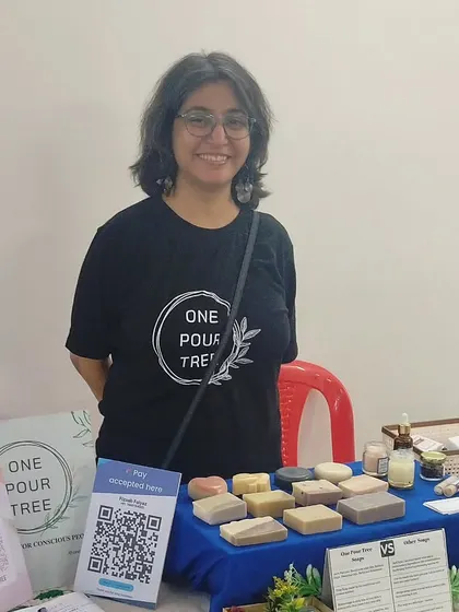 A photo of me at my stall at the Kalpavruksha community event, feeling grateful for the warm welcome.