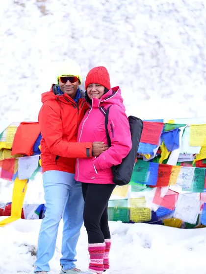 A candid moment between two members of our group, enjoying the stunning snowy views at the high-altitude pass.