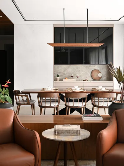 The open-plan living and dining area is the social heart of the home. We used low-slung leather armchairs to create a conversation zone without obstructing the view.