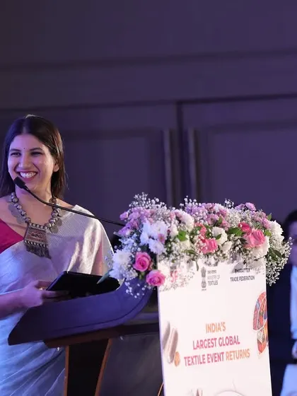 A happy, candid moment at the lectern during the Bharat Tex 2025 expo announcement.