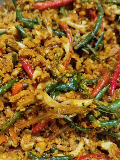 A close-up of the texture of my ginger, garlic, and chilli pickle. You can see the finely chopped ingredients, all coated in a delicious blend of traditional Indian spices.