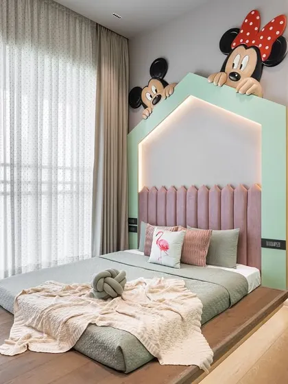 A full view of the playful kids' room at the Kutar Residence. The floor bed and custom Mickey and Minnie headboard create a safe and fun environment for a young child.