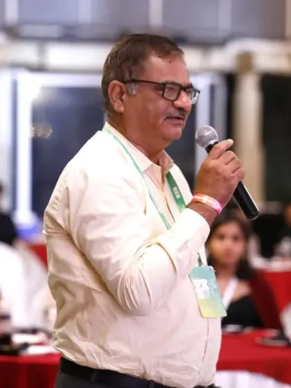 This is a candid shot of an audience member speaking into a microphone during a Q&A session. It demonstrates our ability to discreetly capture moments of interaction and contribution from attendees.