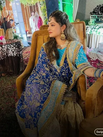 A candid shot of a guest at a wedding. The makeup is glamorous yet appropriate, ensuring she looks her best without outshining the bride.