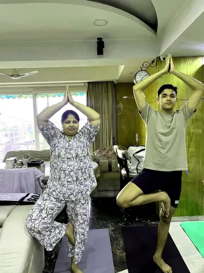 A snapshot from a corporate class showing two participants practicing Tree Pose. It's great to see colleagues supporting each other on their wellness journey.
