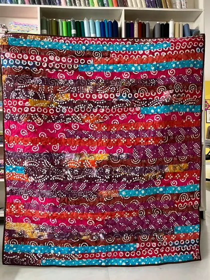 A "Jelly Roll Race" quilt made with colorful batik fabrics. This is a fast and fun way to create a striped, scrappy quilt.