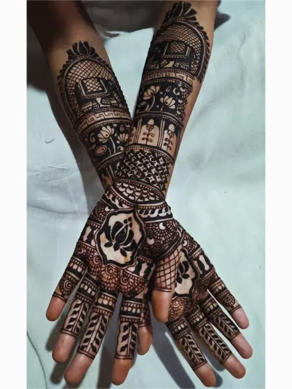 This pose shows how the different elements of a complex design come together. You can see the elephant motif on the arm, the central lotus on the palm, and the detailed finger work all at once.