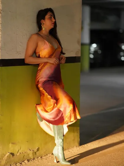 A side profile of the tie-dye dress look, showing how the dress and boots work together.