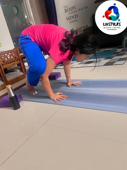 A client practices crow pose, an arm balance that requires significant strength, balance, and concentration.