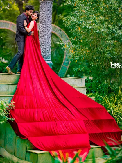 An intimate embrace on the steps, with the cascading red gown creating a waterfall of color. This is a classic, romantic pose that always looks stunning.