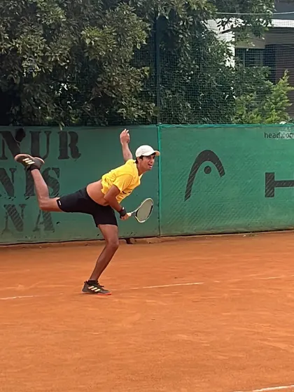 A classic kick serve motion. The body rotation and leg drive are essential for generating the heavy topspin that makes this serve so effective.