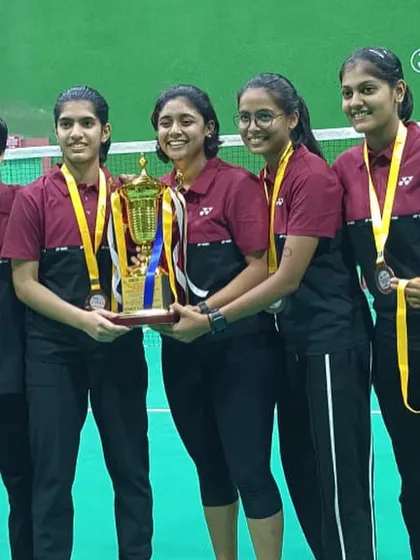 The victorious team holding their trophy at the State Championship. A proud moment for our academy.