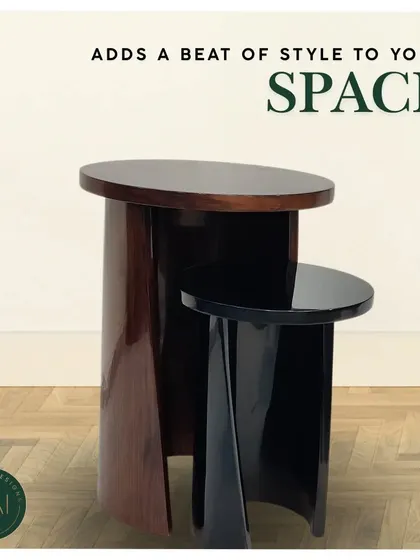 A pair of nesting accent tables in a high-gloss finish. The larger table features a rich wood veneer while the smaller is a solid black, creating a stylish and space-saving solution for any living room.