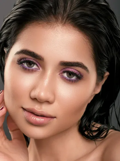 A confident and polished portrait from our shoot with Anu Kaushik. The purple eyeshadow and wet-look hair create a look that is minimal yet bold, perfectly capturing our studio's aesthetic.