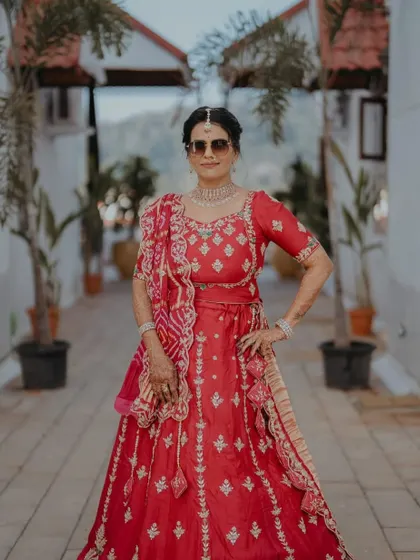 The groom's beautiful mom, looking regal and proud. We went for a classic look that complemented her stunning red lehenga.