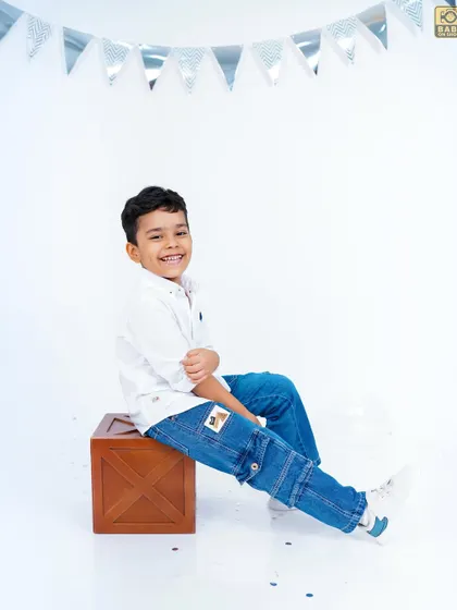 A cool and casual pose from a stylish five-year-old during his birthday photoshoot.