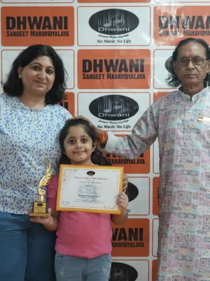 A three-generation photo of success: a student with her mother and her guru.