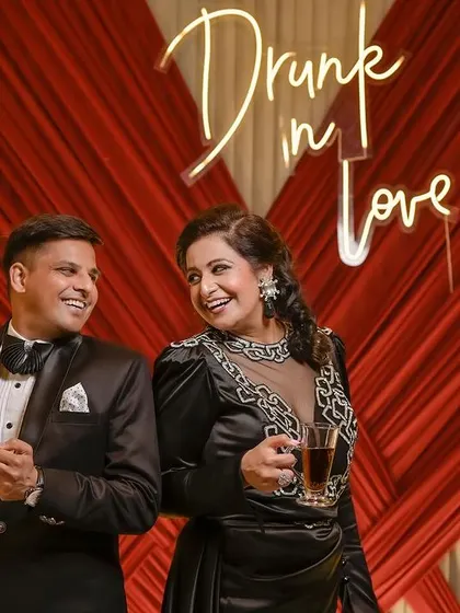 A cheeky and fun portrait of the couple in front of their "Drunk in Love" sign, perfectly capturing the mood of their reception party.